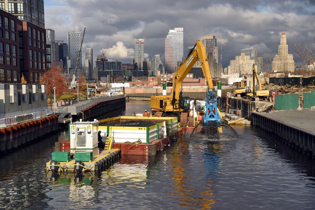 A large machine dredges "black mayonnaise" from the Gowanus Canal.
